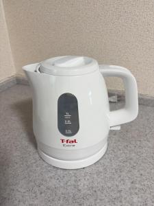 a white slow cooker sitting on top of a counter at ZY House in Osaka