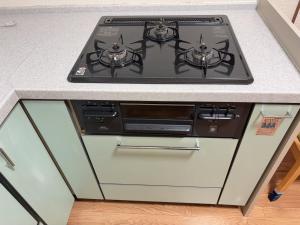 a stove top oven sitting on top of a kitchen counter at ZY House in Osaka