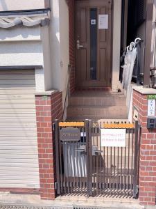 a gate in front of a house with a door at ZY House in Osaka