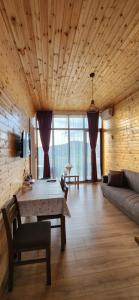 a living room with a table and a couch at Bobokvati Eco Twins in Dagva