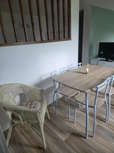 a dining room table and chairs with a candle on it at Petite maison sympathique in Auvers