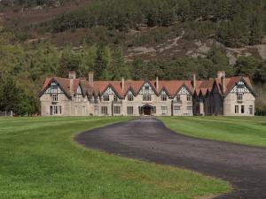 a large house with a road in front of it at Braeriach - Mar Lodge Estate in Ballater