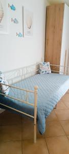 a bed in a room with a bed frame at Gina&Gian Guest House in Olbia