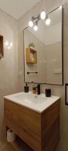 a bathroom with a sink and a large mirror at Gina&Gian Guest House in Olbia +19 photos