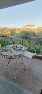 a table and chairs on a balcony with a view at Gina&Gian Guest House in Olbia