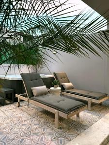 two chairs and a couch sitting on a patio at A Casa Di Zoi in Archangelos