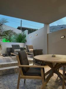a patio with a wooden table and chairs at A Casa Di Zoi in Archangelos