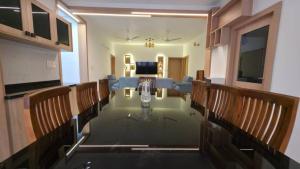 a conference room with a glass table and chairs at Science House Lux Inn in Kadayirippu