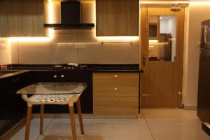 a kitchen with a table and a chair in it at Science House Lux Inn in Kadayirippu