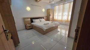 a bedroom with a large bed and a window at Science House Lux Inn in Kadayirippu
