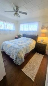 a bedroom with a bed and a ceiling fan at Anissa Shasta Hostel in Weed