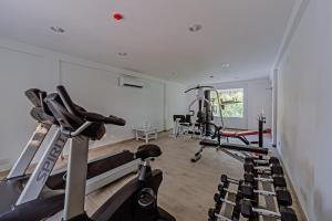 a gym with several treadmills in a room at Sandies Bathala in Bathala