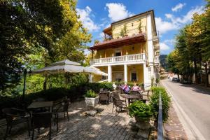 an outdoor cafe with tables and chairs in front of a building at Hotel Mazzocca in Caramanico Terme
