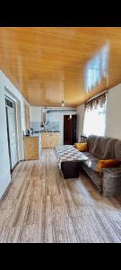 a living room with a couch and a table at Tsatʼer Guest House in Tsatʼer