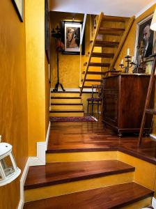 a hallway with a staircase with yellow walls at Casa Lovisoni in Cervignano del Friuli +7 photos