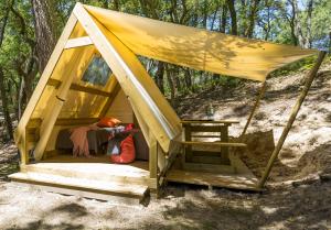 a tent with a person sitting inside of it at camping des ribieres in Confolens