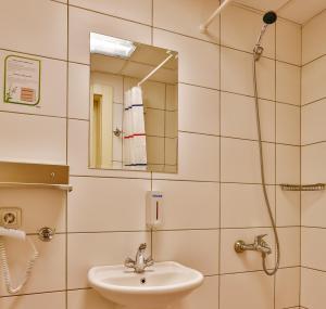 a bathroom with a sink and a mirror at Han Hotel Istanbul in Istanbul