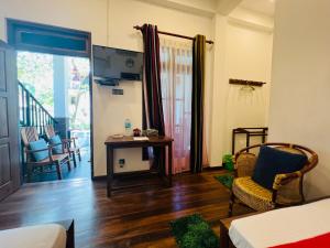 a living room with a table and chairs at Ceylonima Home Stay in Anuradhapura