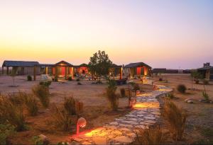 a group of lodges in the desert at sunset at SAMA Ras Al Jinz Ecolodge in Sur