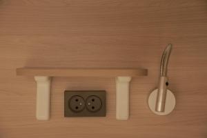 an electrical outlet on a wooden wall at PREMIUM DOO Hostel in Tashkent
