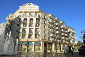 a building with a fountain in front of it at PREMIUM DOO Hostel in Tashkent