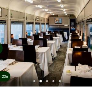 a dining car of a train with white tables and chairs at We Love the Bay short stays private suite 1 to 3 days in Saint Leonards