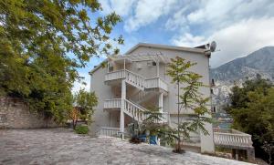 a white building with stairs on the side of it at Muo Suntime apartment in Muo