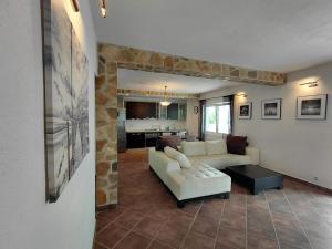 a living room with a couch and a table at Muo Suntime apartment in Muo