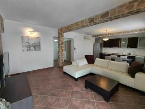 a living room with a couch and a table at Muo Suntime apartment in Muo