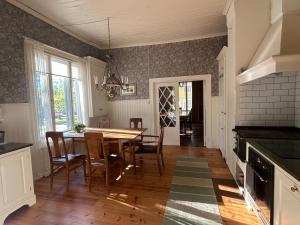 a kitchen with a table and chairs and a dining room at Tornvillan in Mariehamn