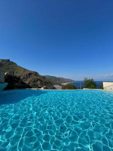 a swimming pool with a view of the ocean at Taormina Panoramic Apartment - Taormina Holidays in Taormina