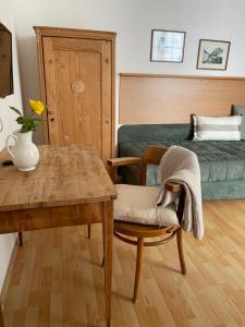 a living room with a table and a couch at Weinlandhaus in Mitterretzbach +24 photos