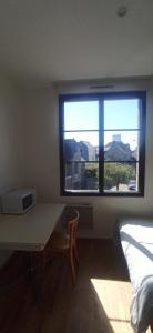 a room with a desk and a window and a bed at Near Train Station in Rennes