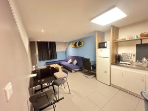 a small living room with a couch and a table at Cosytel in Bègles +13 photos