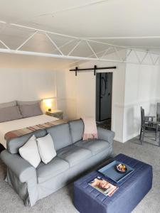 a living room with a couch and a bed at Little Eden in Matamata