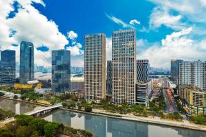 a city skyline with tall buildings and a river at HeeFun Apartment GZ -Poly World Trading Center in Guangzhou