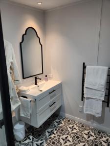a bathroom with a sink and a mirror at Little Eden in Matamata
