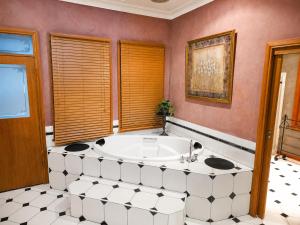 a bathroom with a large tub in a room at Charnwood Cottages in Warburton +29 photos