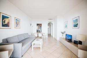 a living room with a couch and a table at Taormina SeaView Apartment - Taormina Holidays in Taormina
