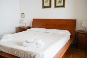 a bedroom with a bed with two towels on it at Taormina SeaView Apartment - Taormina Holidays in Taormina