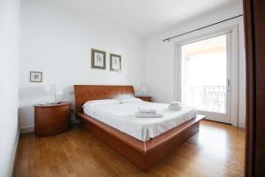 a bedroom with a large bed and a large window at Taormina SeaView Apartment - Taormina Holidays in Taormina