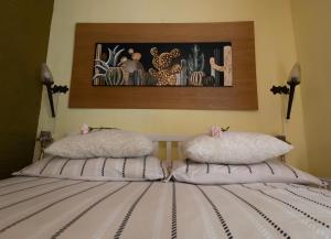 a bed with two pillows on top of it at Studio Unique in Enschede
