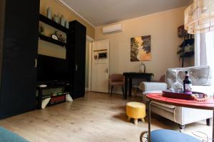 a living room with a table and a tv at Studio Unique in Enschede +18 photos