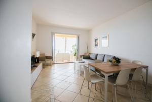 a living room with a table and a couch at Taormina SeaView Apartment - Taormina Holidays in Taormina +22 photos