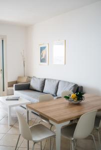 a living room with a table and a couch at Taormina SeaView Apartment - Taormina Holidays in Taormina