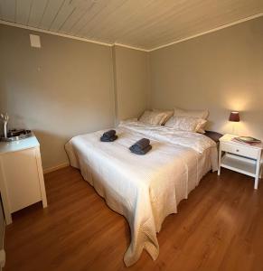 a bedroom with a bed with a white bedspread at StarapApartment Odda 3 BR in Odda