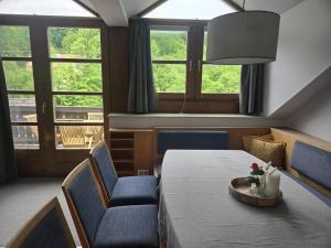 a room with a table and chairs and windows at Ferienwohnung Marienhof in Bad Aussee