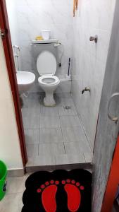 a small bathroom with a toilet and a sink at Bella Accomodations, Mombasa in Bamburi +7 photos