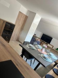 a dining table and chairs in a living room at Apartma Tri Planike in Mojstrana