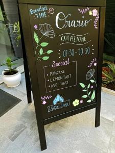 a sign for a cafe with flowers on it at Hotel Villa Irene & Spa in Rimini